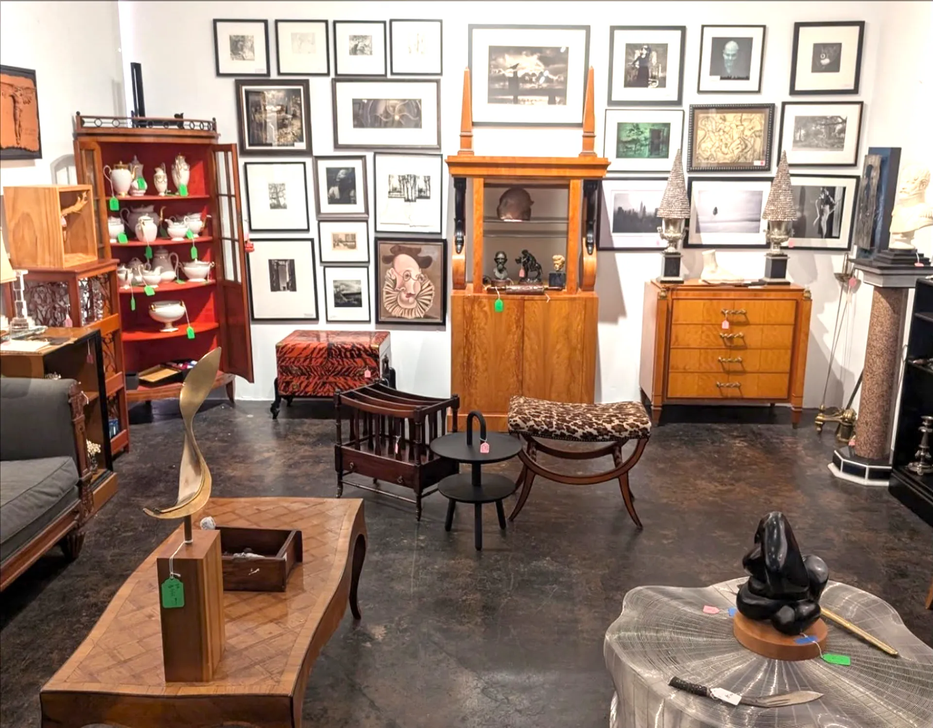 Estate sale interior with antiques, furniture, and collectibles
